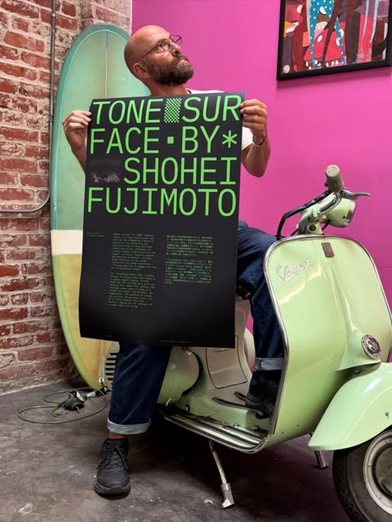 Event poster held up in the studio